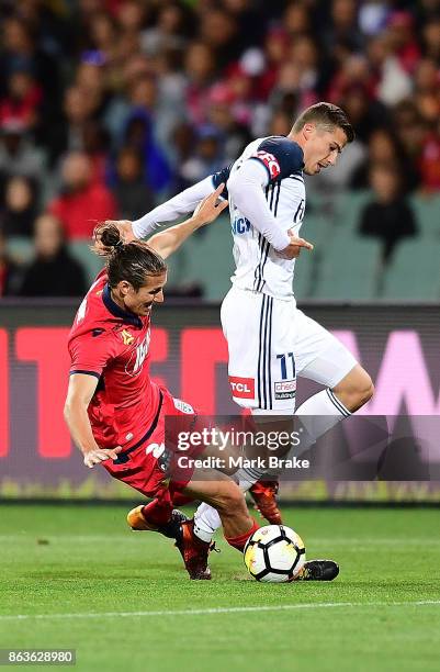 Adelaide's MIchael Marrone taaakes on Melboune's MItchell Austin during the round three A-League match between Adelaide United and Melbourne Victory...