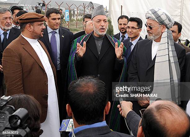 Afghan President Hamid Karzai speaks after registering as a candidate for August presidential elections as controversial warlord Mohammad Qasim Fahim...