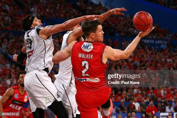 Lucas Walker of the Wildcats looks to pass the ball following a rebound during the round three NBL match between the Perth Wildcats and Melbourne...