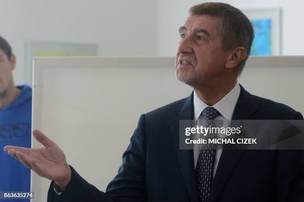 Czech billionaire Andrej Babis, chairman of the ANO movement , talks to the media at a polling station during the first day of the Czech elections on...