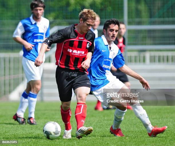 Oliver Sorg of SC Freiburg and Enis Salkovic of FC Carl Zeiss Jena battle for the ball during the DFB Juniors Cup match between FC Carl Zeiss Jena...