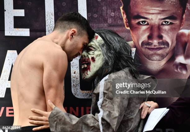 Renald Garrido of France wearing a halloween costume goes head to head with Tyrone McKenna of Northern Ireland at the weigh in for the Ryan Burnett v...