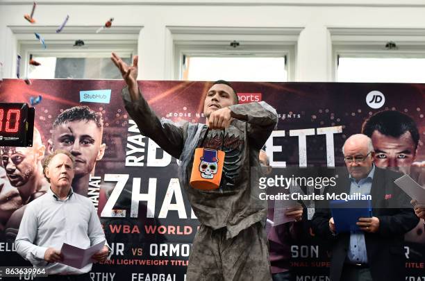 Renald Garrido of France wearing a halloween fancy dress outfit throws sweets to the crowd during the weigh in for the Ryan Burnett v Zhanat...