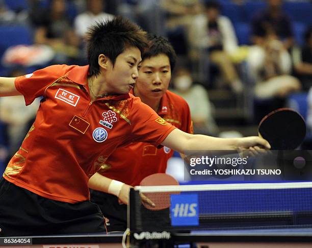 Chinese pair Guo Yue hits a return as teammate Li Xiaoxia looks on during their match against compatriots Ding Ning and Guo Yan in the final of the...