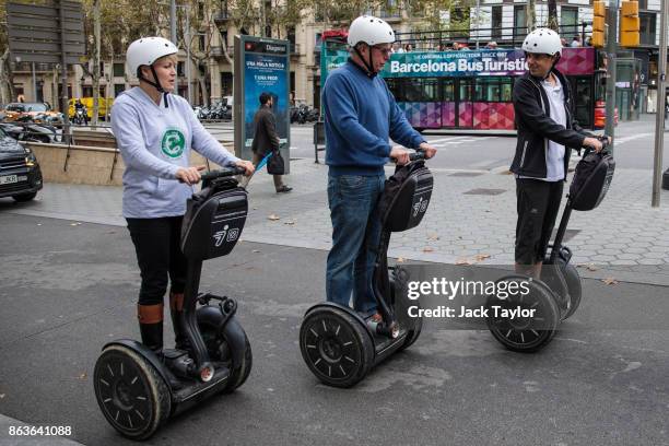 Tourists take a tour on Segways on October 20, 2017 in Barcelona, Spain. The Spanish government is to take steps to suspend Catalonia's autonomy by...