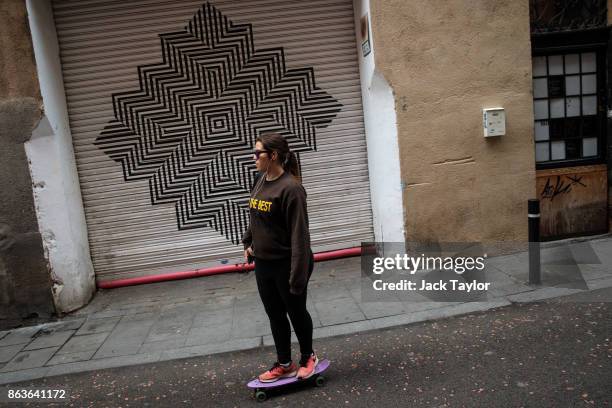 Woman skateboards down a narrow street on October 20, 2017 in Barcelona, Spain. The Spanish government is to take steps to suspend Catalonia's...