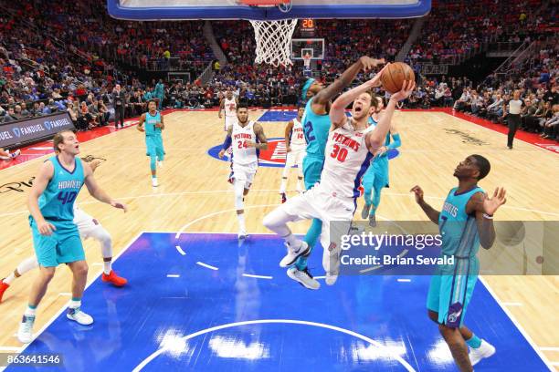 Jon Leuer of the Detroit Pistons drives to the basket against the Charlotte Hornets at the Little Caesars Arena in Detroit, Michigan on October 18,...