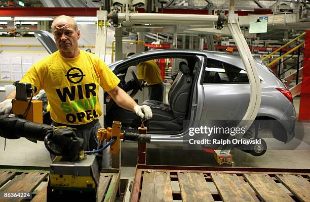 An employee of German carmaker Adam Opel GmbH works on an Opel Corsa at a plant on May 4, 2009 in Eisenach, Germany. Representatives of the German...