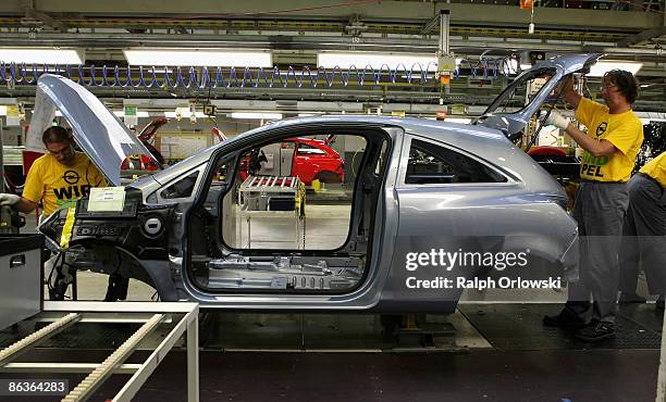 Employees of German carmaker Adam Opel GmbH work on an Opel Corsa at a plant on May 4, 2009 in Eisenach, Germany. Representatives of the German...