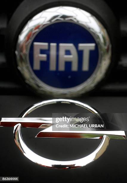 Logo of German carmaker Opel is photographed in front of a logo of Italian carmaker Fiat in the eastern German town of Borgsdorf on May 4, 2009. Fiat...