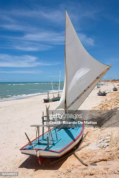 traditional sail boat on brazilian beach - canoa quebrada stock pictures, royalty-free photos & images