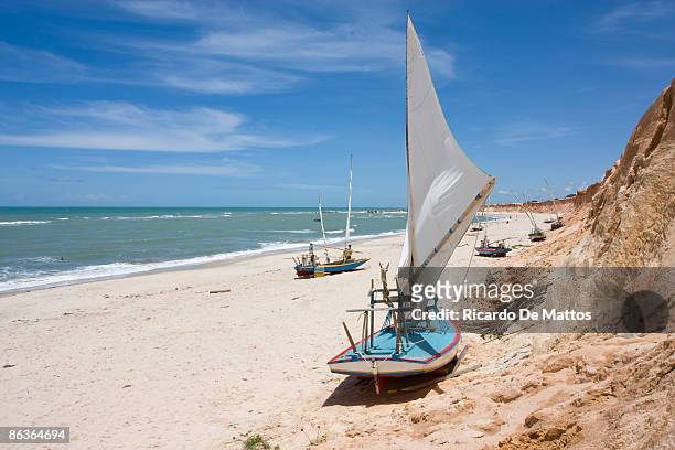 traditional sail boats on brazilian beach - canoa quebrada stock pictures, royalty-free photos & images