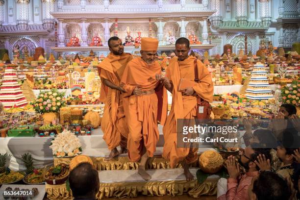 Guru Mahant Swami Maharaj is helped off stage after leading a Diwali service at Neasden Temple on October 20, 2017 in London, England. BAPS Shri...