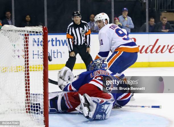 John Tavares of the New York Islanders scores on the shootout against Henrik Lundqvist of the New York Rangers at Madison Square Garden on October...