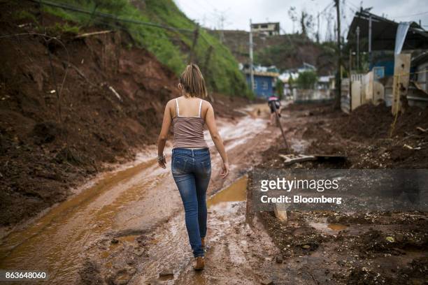 Resident walks along a muddy road in Barranquitas, Puerto Rico, on Wednesday, Oct. 18, 2017. At this stage in the recovery from the Category 4 storm,...