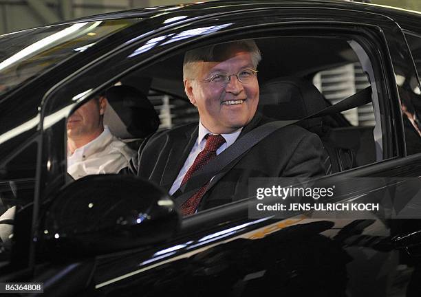 German Foreign minister Frank-Walter Steinmeier sits in an Opel Corsa at the company's plant in the eastern German city of Eisenach on May 4, 2009....