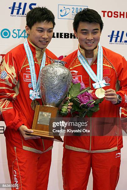 Wang Hao and Chen Qi of China pose with their trophy and gold medals on the podium during the award ceremony for the Men's Doubles final match of the...