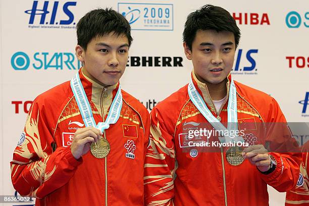 Wang Hao and Chen Qi of China pose with their gold medals on the podium during the award ceremony for the Men's Doubles final match of the World...