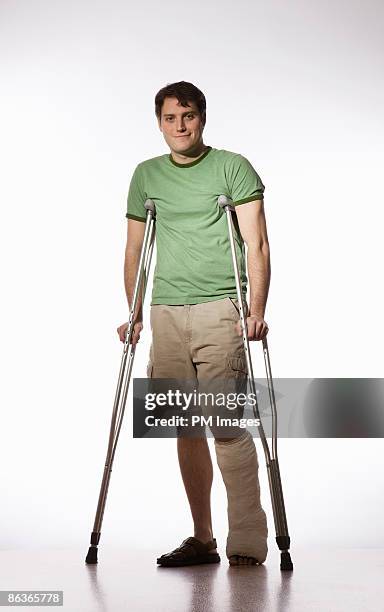 man with broken leg - crutches stockfoto's en -beelden