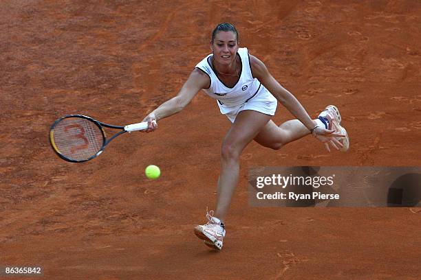 Flavia Pennetta of Italy plays a forehand during her first round match against Tsvetana Pironkova of Bulgaria during day one of the Internazionali...