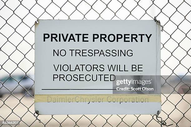Sign with the old Daimler Chrysler Corporation name taped over is posted on the fence surrounding the Belvidere Assembly plant May 4, 2009 in...