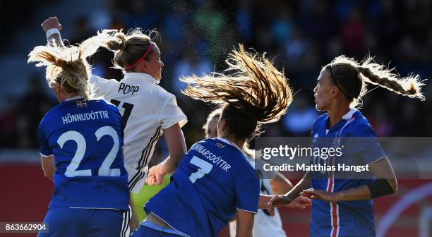Alexandra Popp of Germany jumps for a header with Sara Bjoerk Gunnarsdottir of Iceland and Rakel Hoennudottir of Iceland during the 2019 FIFA Women's...