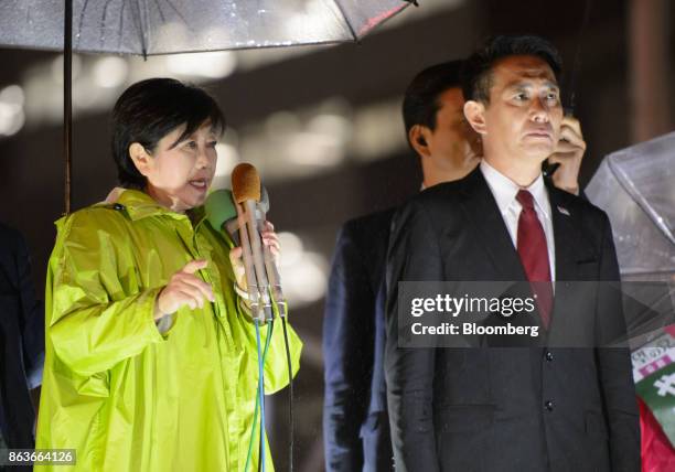 Yuriko Koike, governor of Tokyo and leader of the Party of Hope, left, speaks as she stands next to Seiji Maehara, leader of the Democratic Party,...