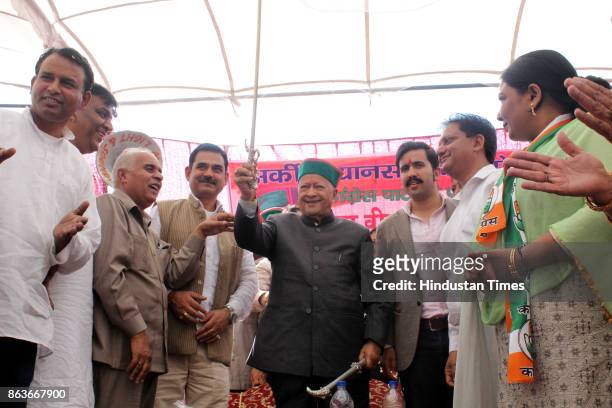 Chief Minister Virbhadra Singh greets people during the public meeting after filing the nomination for Vidhan Sabha elections from Arki constituency,...