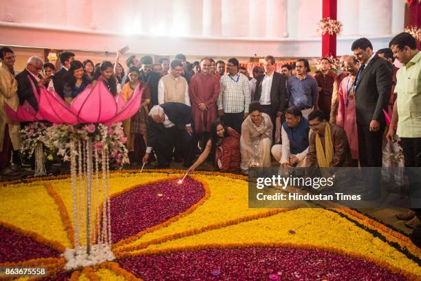 And CEO Ashishkumar Chauhan along with Bollywood actress Richa Chadda burns candle during Muhurat trading during Lakshmi Pujan on the occasion of...