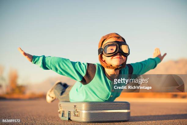 young boy dreams of air travel - independence imagens e fotografias de stock