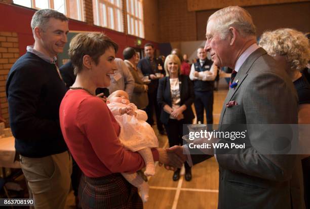 Prince Charles, Prince of Wales greets Nicola and Thomas Hampton and daughter Leyla, 11 weeks old, who lost their poultry farm in the flooding during...