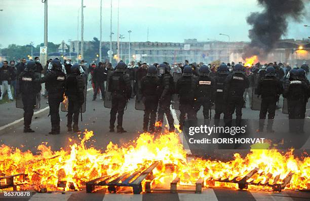 Policemen stand guard in front of prison guards blocking access to the prison in Fleury-Merogis, outside of Paris, clash with French police on May 4,...