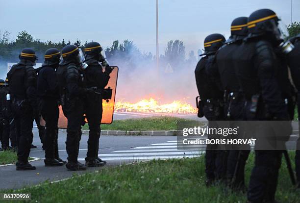 Policemen stand guard in front of prison guards blocking access to the prison in Fleury-Merogis, outside of Paris, clash with French police on May 4,...