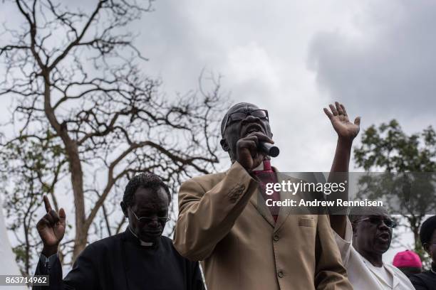 Pastor preaches a the funeral for three men killed by the police in an opposition protest the week prior, on October 20, 2017 in Bondo, Kenya....