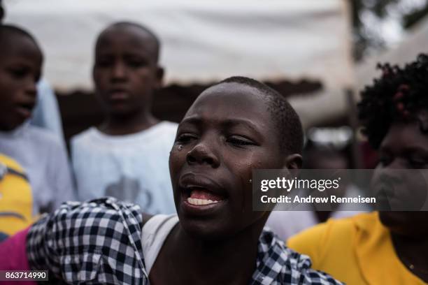Susan Duong'a cries during the funeral service for her brother, Edward Ochieng Odhiambo, who was one three men killed by the police in an opposition...