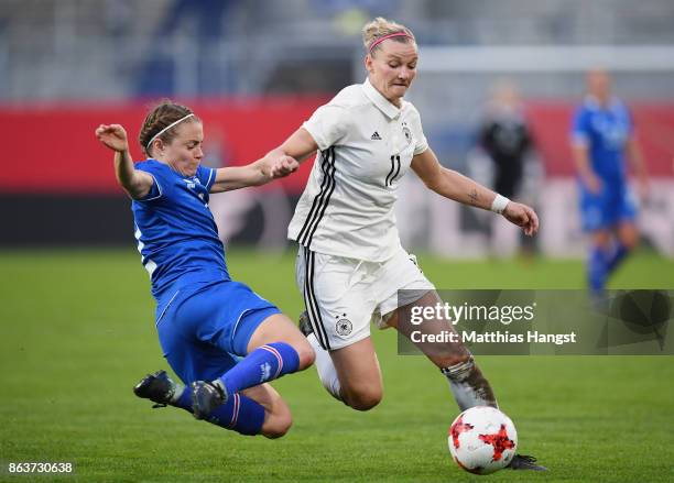 Alexandra Popp of Germany is challenged by Sif Atladottir of Iceland during the 2019 FIFA Women's World Championship Qualifier match between Germany...