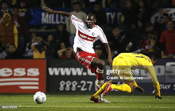 Bakary Soumare of the Chicago Fire trips Robert de Pinho of Club America during the second half at Toyota Park on April 29, 2009 in Bridgeview,...