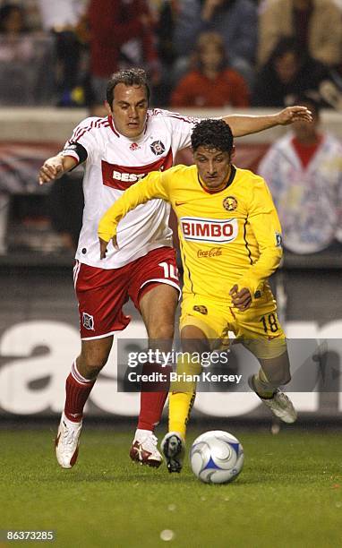 Cuauhtemoc Blanco of the Chicago Fire and Angel Reyna of Club America chase after the ball during the first half at Toyota Park on April 29, 2009 in...