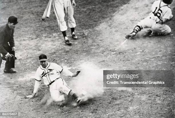 Enos Slaughter of the Cardinals slides home with the winning run in game seven of the World Series in Sportsmans Park in St. Louis on October 15,...