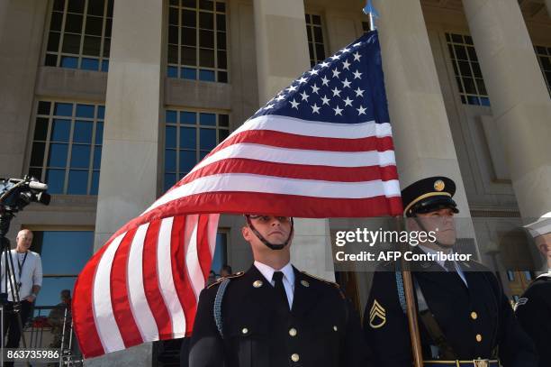 Flag flies before Secretary of Defense Jim Mattis hosts an enhanced honor cordon welcoming Florence Parly, minister for the Armed Forces, France, to...