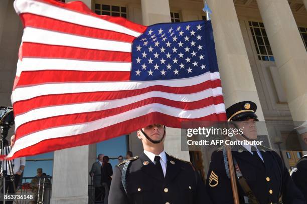 Flag flies before Secretary of Defense Jim Mattis hosts an enhanced honor cordon welcoming Florence Parly, minister for the Armed Forces, France, to...