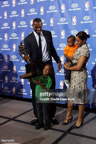 LeBron James of the Cleveland Cavaliers shares the stage with sons LeBron Jr. And Bryce and their mother Savannah Brinson after he was named the NBA...