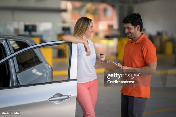 woman taking her broken car to the mechanic - happy client by broken car stock pictures, royalty-free photos & images