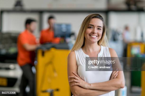 woman taking her car to the auto repair shop - happy client by broken car stock pictures, royalty-free photos & images