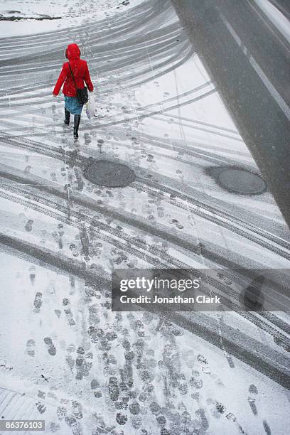 woman in red coat walking in the snow - quebec icy trail stock pictures, royalty-free photos & images