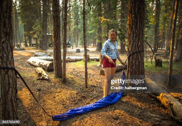 mujer colocación de hamaca que acampa - bosque nacional de umpqua fotografías e imágenes de stock