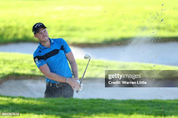 Danny Willett of England hits from a bunker on the 18th hole during day two of the Andalucia Valderrama Masters at Real Club Valderrama on October...