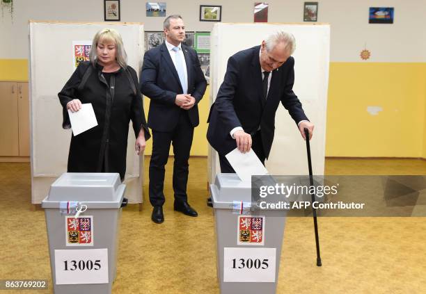 Czech President Milos Zeman and his wife Ivana cast their ballots at a polling station during the first day of voting in the Czech elections on...