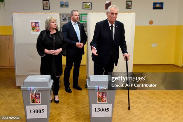 Czech President Milos Zeman and his wife Ivana cast their ballots at a polling station during the first day of voting in the Czech elections on...