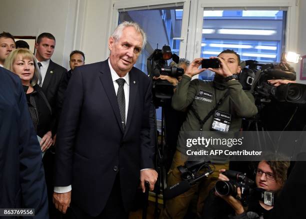 Czech President Milos Zeman and his wife Ivana arrive to cast their ballots at a polling station during the first day of voting in the Czech...